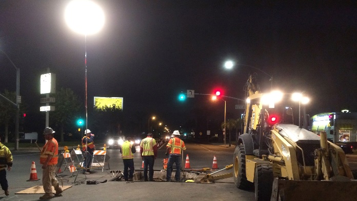 Construction workers using balloon lights to do road construction during night